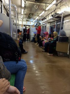 Security guards in each car, and women and men remain separate for the most part save for couples in the  mixed cars. The flow seems to be created by the crowd and maintained by the guards.